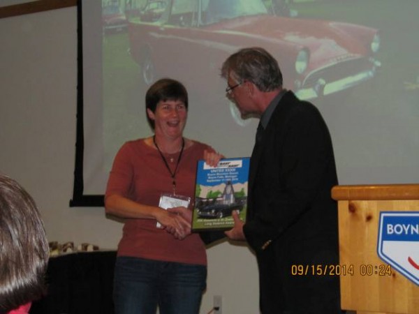Lora Sharkey accepting the Longest Distance Award from John Logan